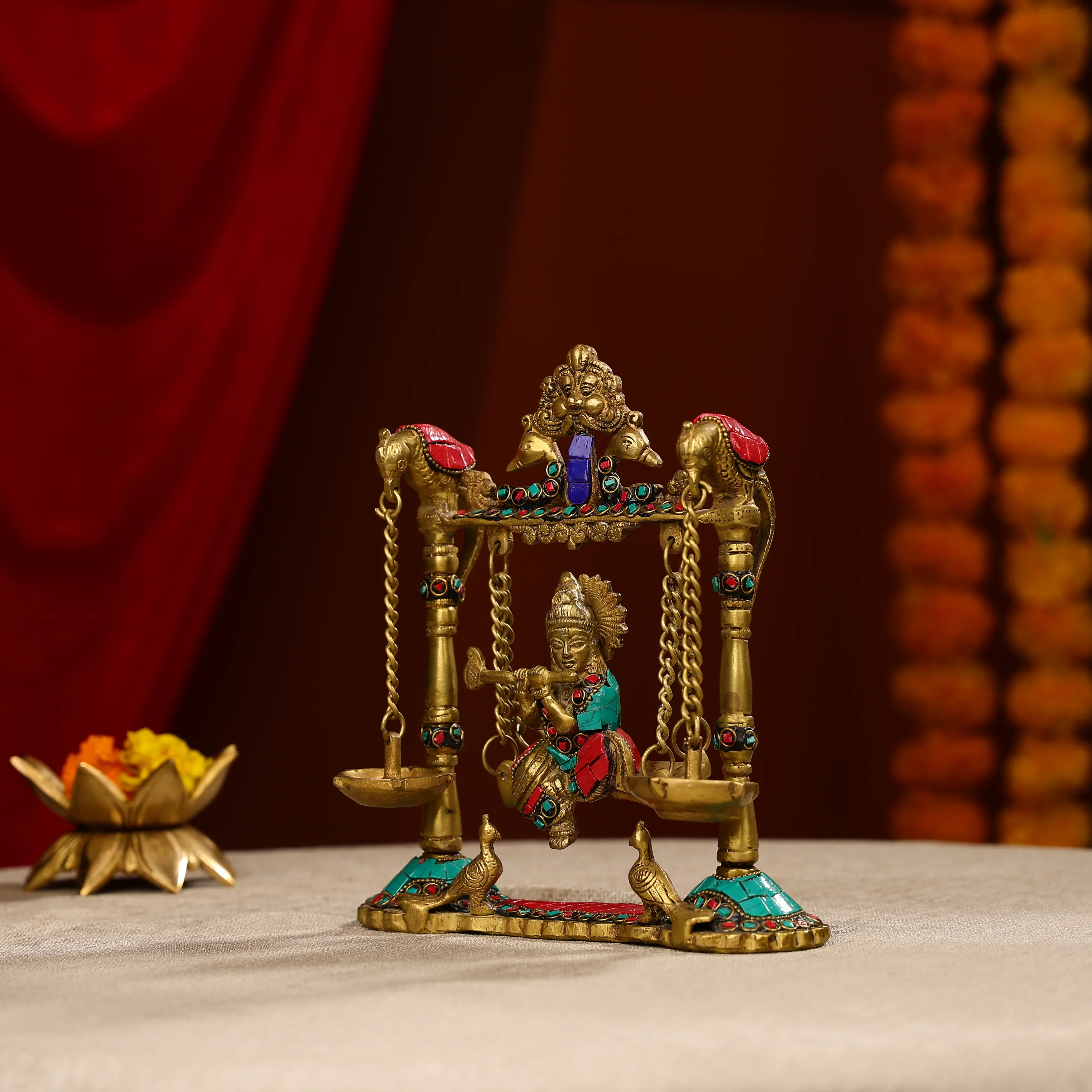 9" Brass Lord Krishna Fluting Idol on Swings With Hanging Panch Diya on Both Sides With Seated Peacocks | Stone Work - Image 2